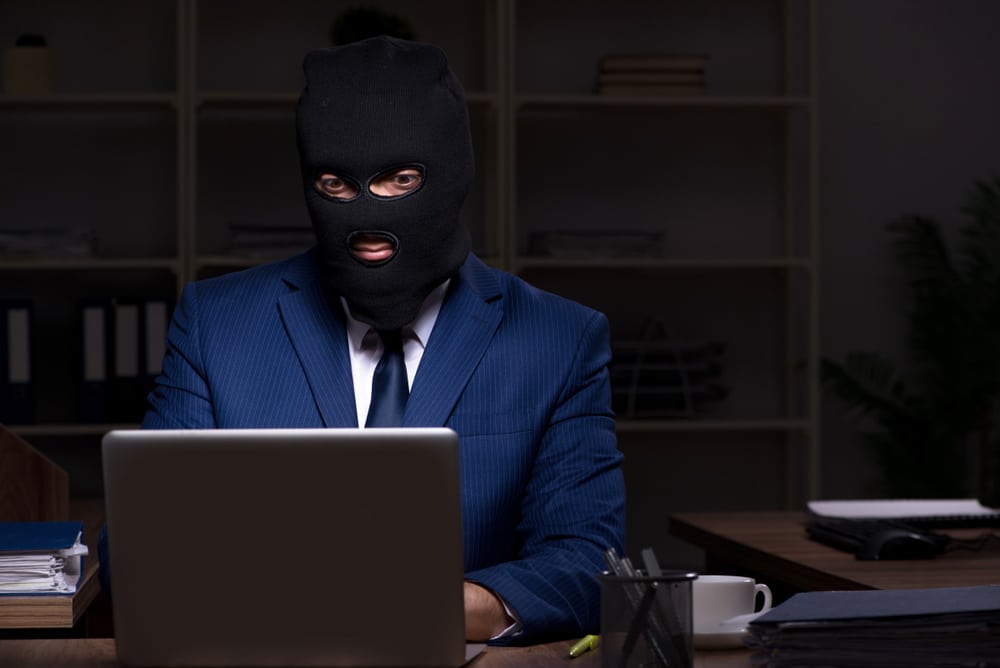 MaleEmployeeStealingInformationInTheOfficeNightTime