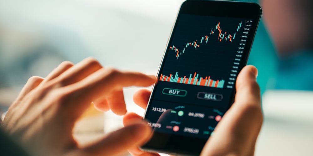 WomanTouchingMobilePhoneInvestingApplicationStockMarketInvestmentApp
