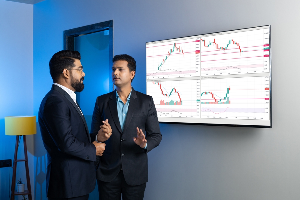 Indian,Businessmen,Colleagues,Trading,And,Discussing,Stocks,Online,In,Office.