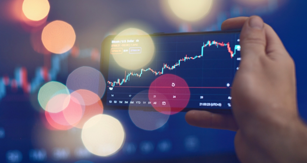 Trader,Investor,Broker,Holding,Finger,Using,Cell,Phone,App,Executing